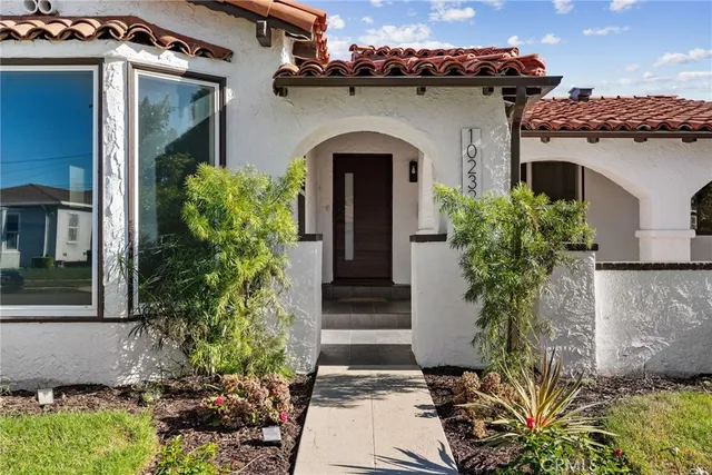 a front view of a house with plants