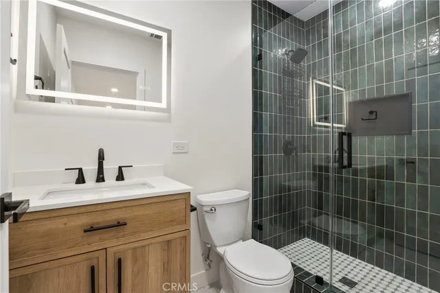 a bathroom with a sink toilet and shower