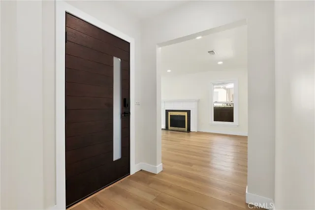 a view of a hallway with wooden floor