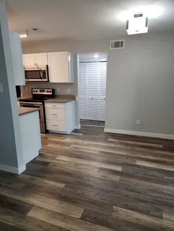 a kitchen with granite countertop a sink and cabinets