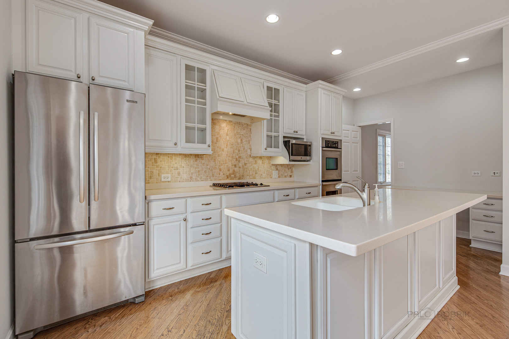 1216 Edgewood Road Lake Forest, IL 60045 - Photo 12 of 35 a kitchen with kitchen island white cabinets and stainless steel appliances