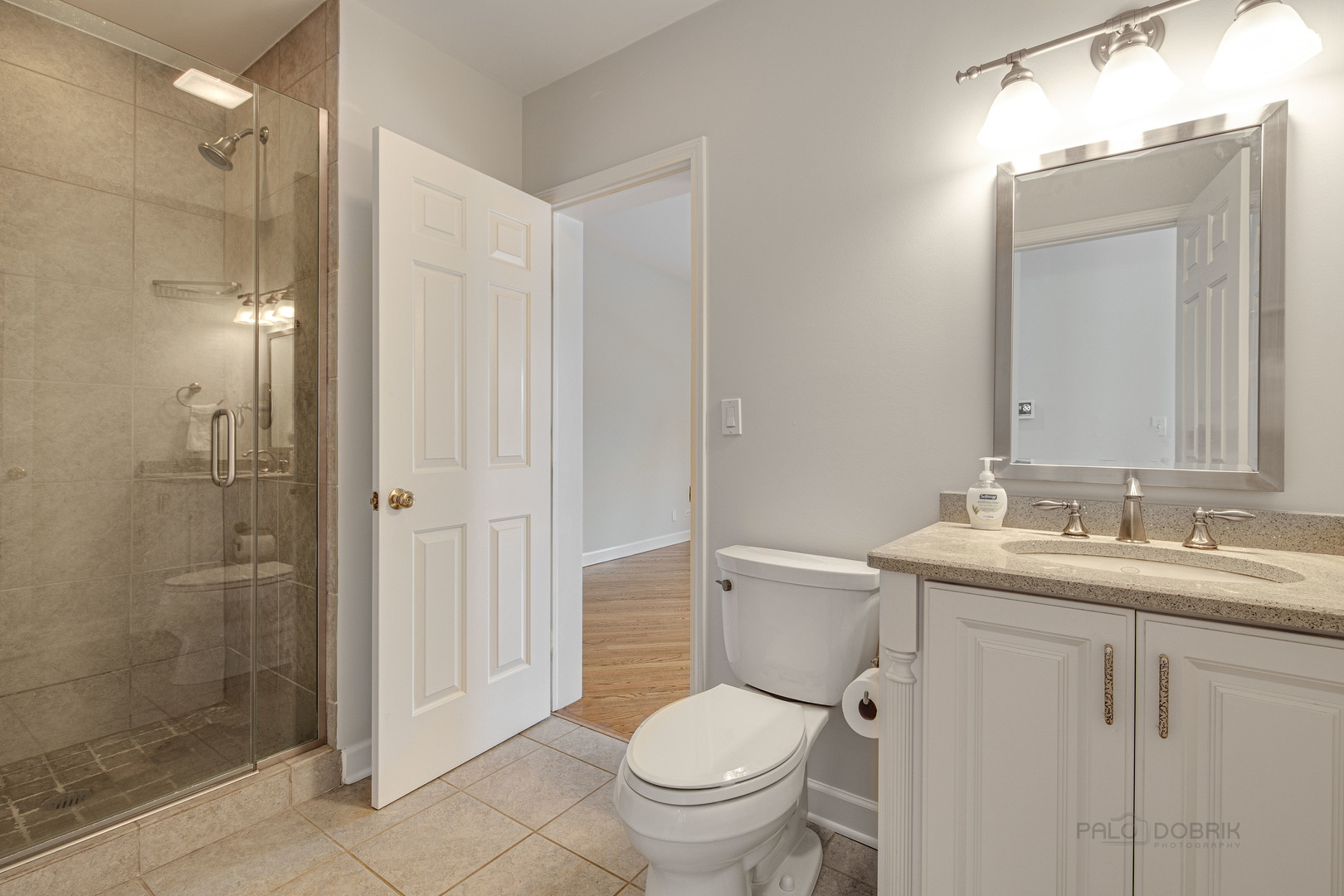 1216 Edgewood Road Lake Forest, IL 60045 - Photo 17 of 35 a bathroom with a toilet sink vanity and shower