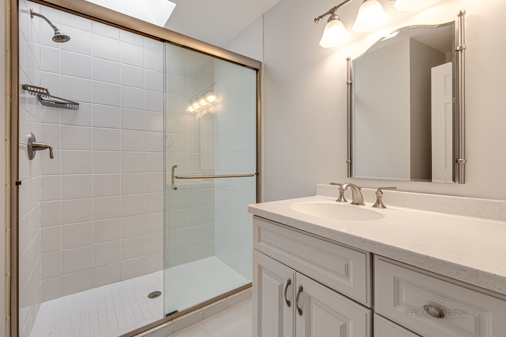 1216 Edgewood Road Lake Forest, IL 60045 - Photo 28 of 35 a bathroom with a shower sink and mirror