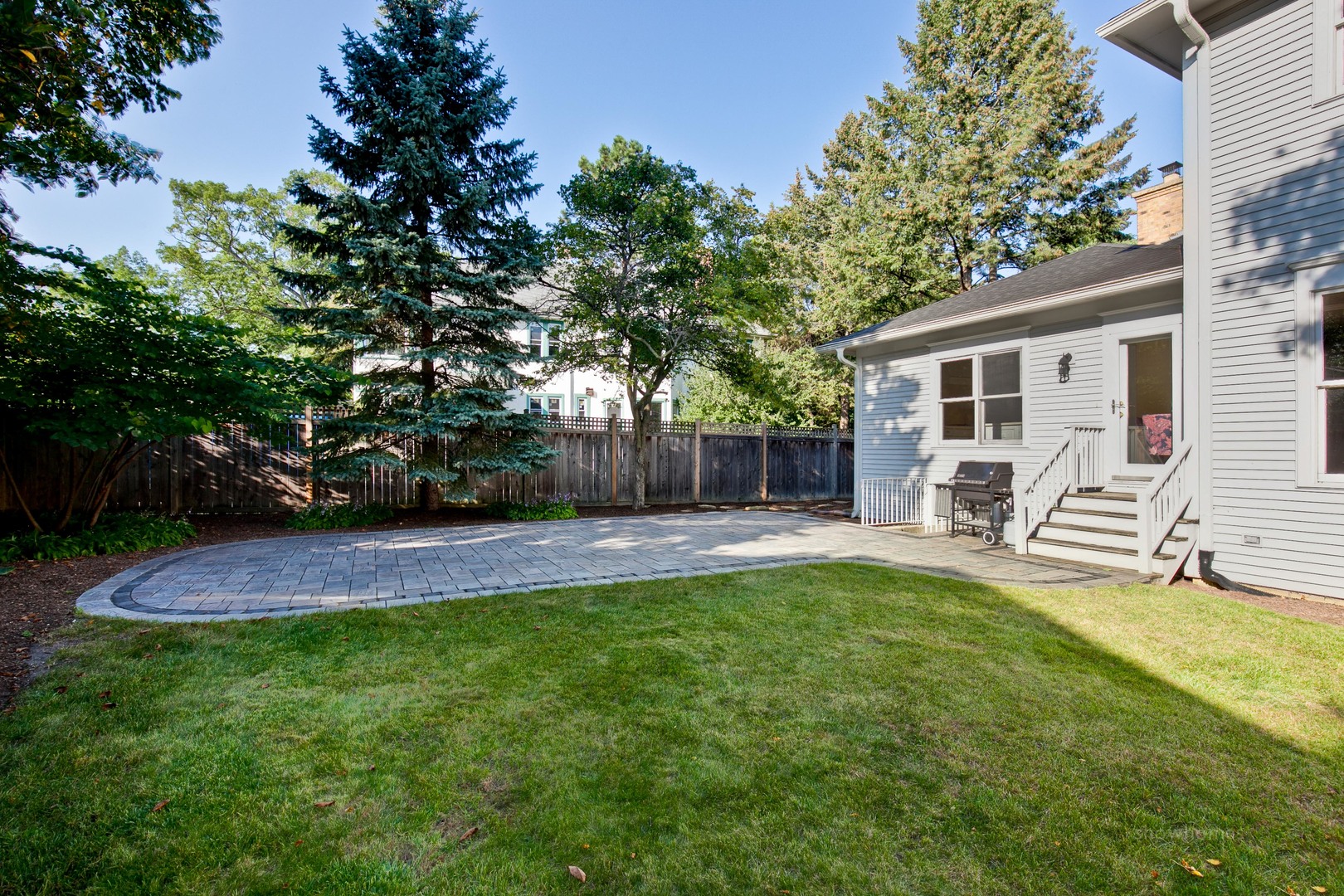 1216 Edgewood Road Lake Forest, IL 60045 - Photo 33 of 35 a view of a house with a patio and a yard