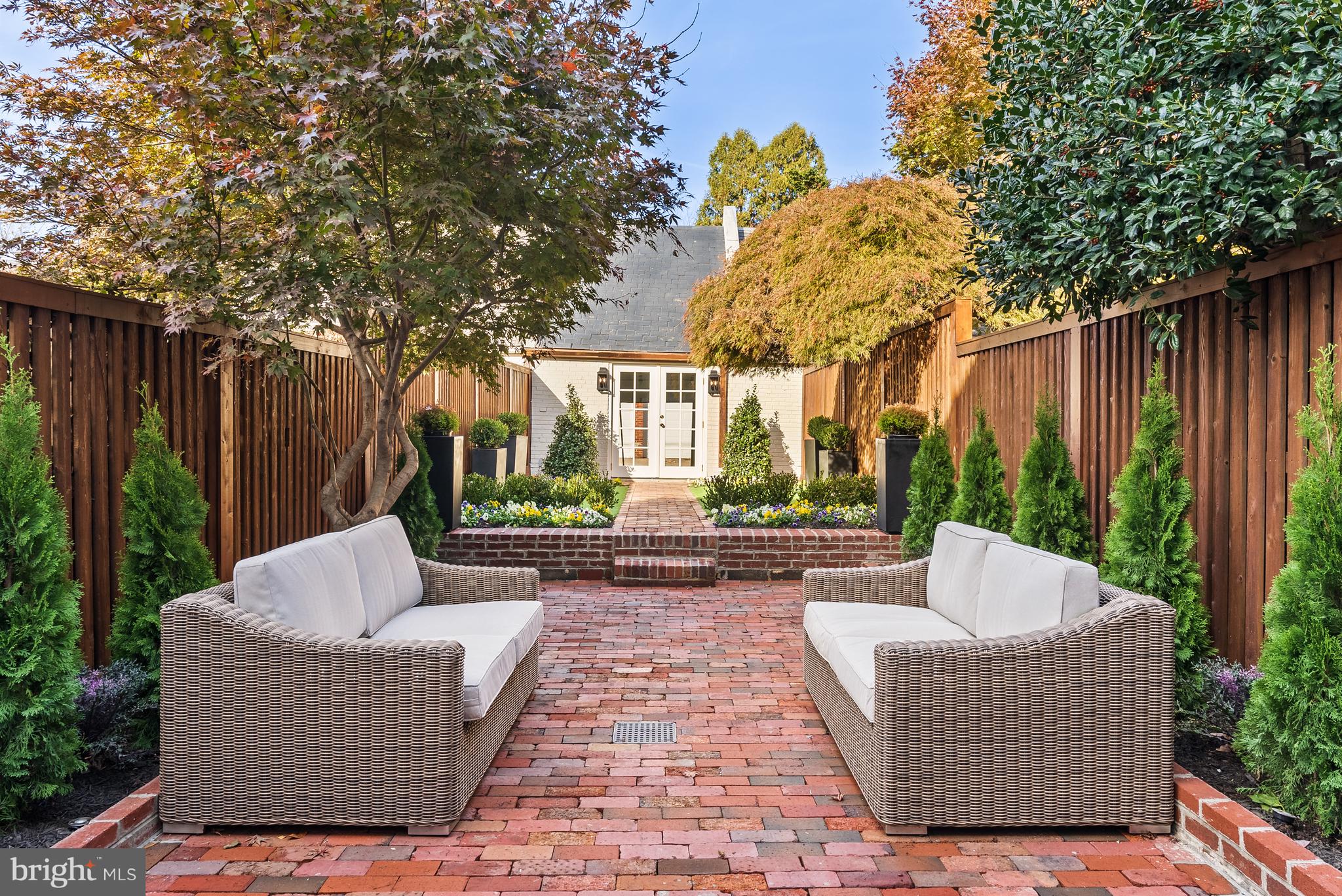 3321 Dent Place Northwest Washington, DC 20007 - Photo 7 of 29 a patio with couches and a fire pit with wooden fence