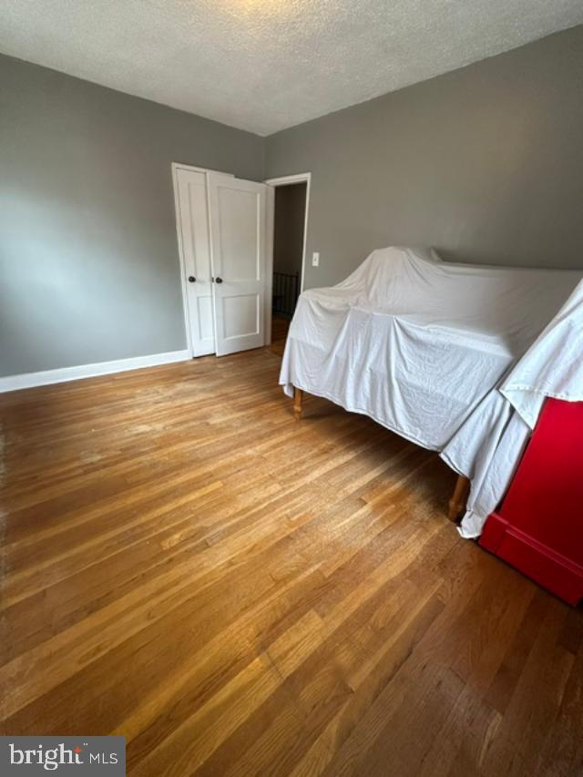 1619 Inverness Avenue Baltimore, MD 21230 - Photo 21 of 30 a bedroom with a bed and wooden floor