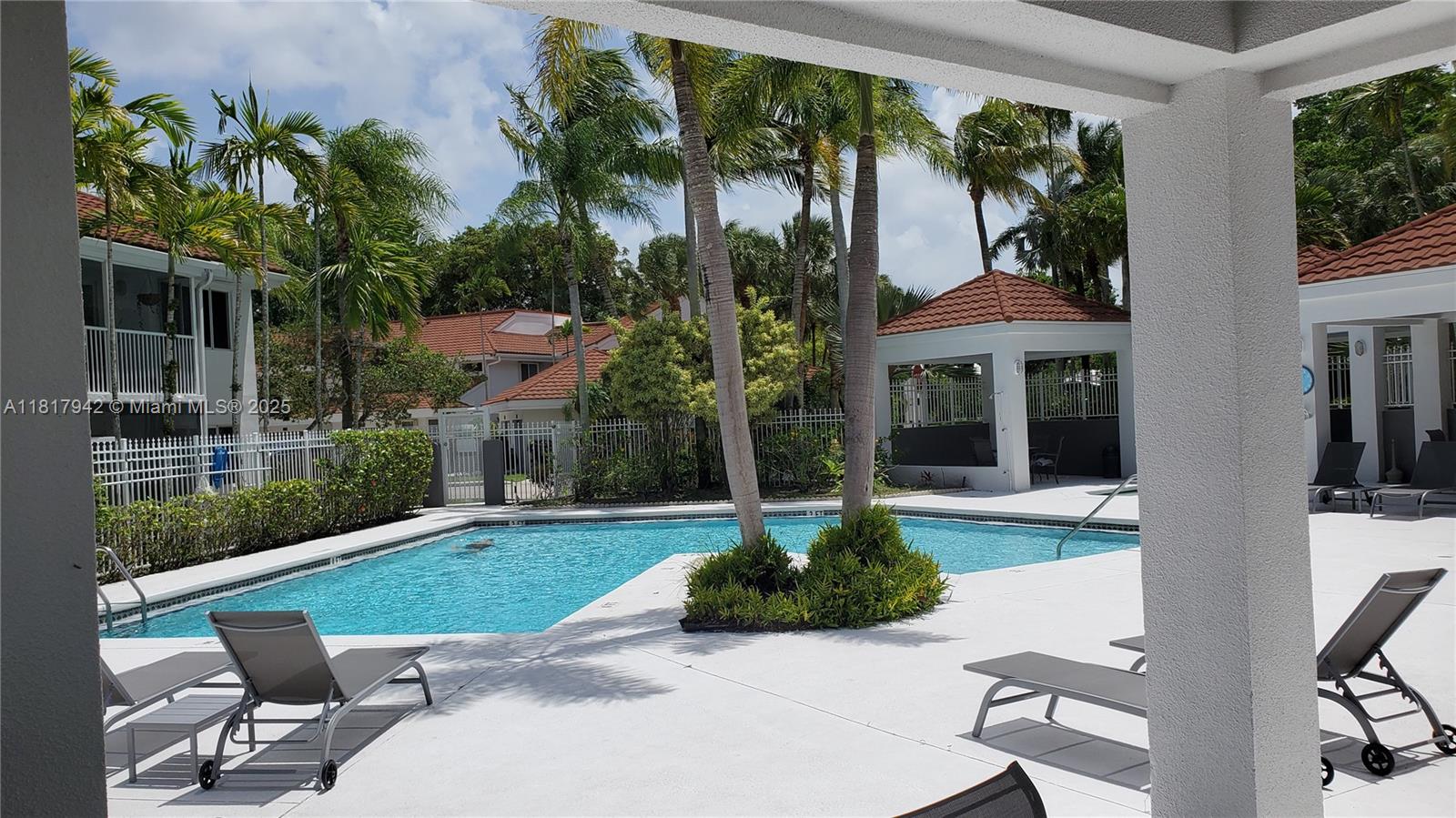 Parc Court Condominiums Plantation, FL 33324 - Photo 25 of 45 a view of a patio with table and chairs potted plants and floor to ceiling window