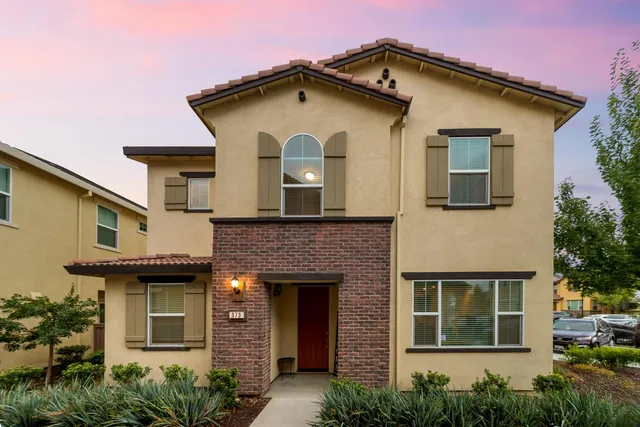 a front view of a house with a garden