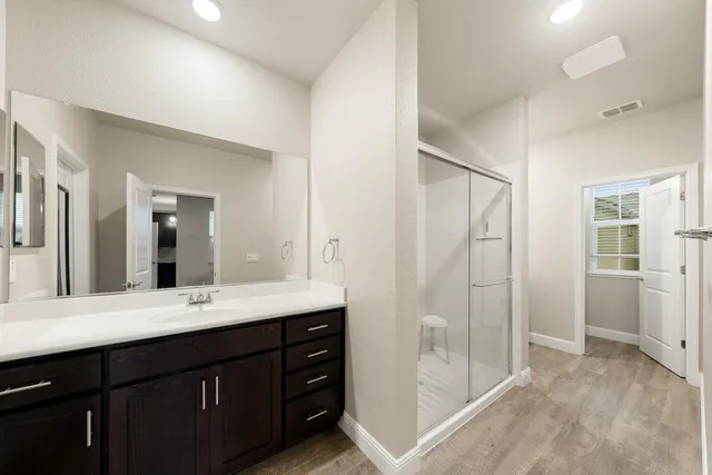 a bathroom with a sink a mirror and a shower