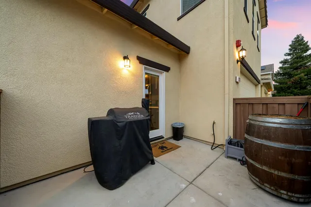 a front view of a house with a garden and mountain view