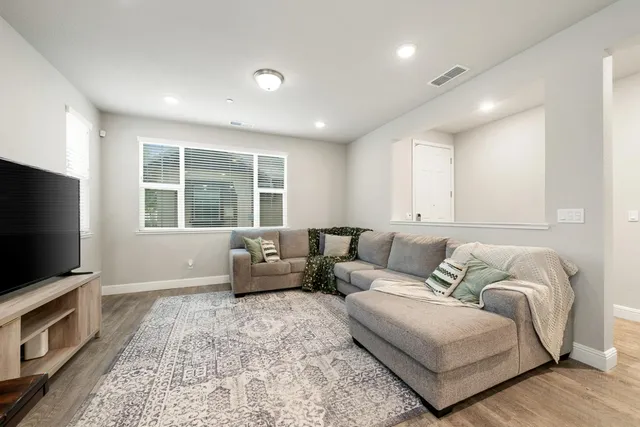 a view of a a dining room with furniture window and wooden floor
