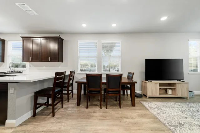 a living room with furniture and kitchen view