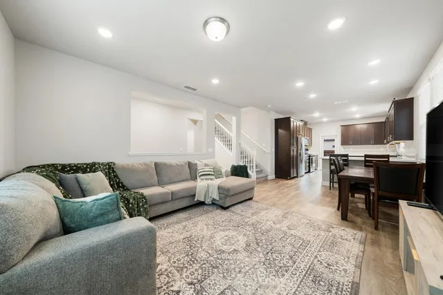 a kitchen with a table chairs refrigerator and microwave