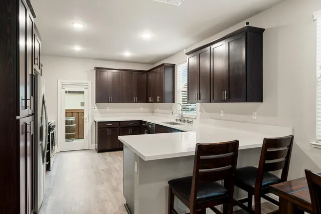 a kitchen with stainless steel appliances a stove a microwave and a refrigerator