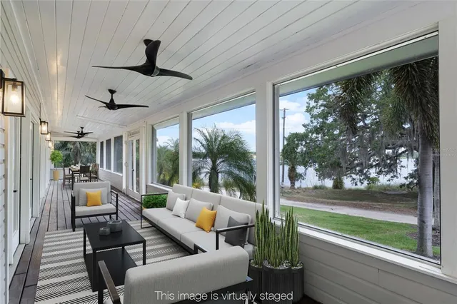 a view of a room with a ceiling fan and a ceiling fan