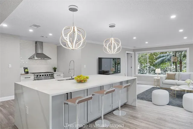 a kitchen with a sink appliances and cabinets