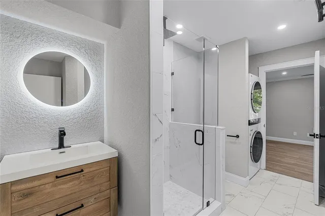 an empty room with wooden floor cabinet and windows