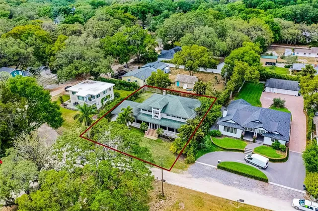 an aerial view of house with yard swimming pool and outdoor seating