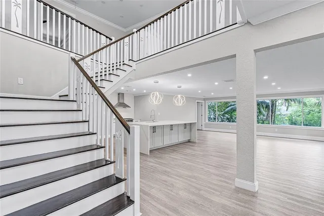 a view of staircase with white walls and a window