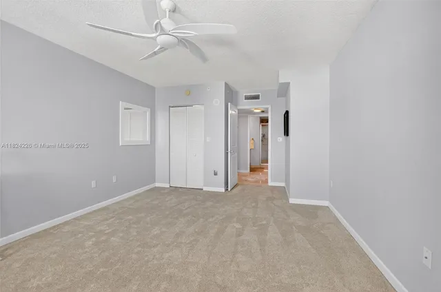 a view of empty room with fan