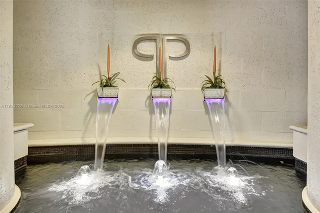 a view of a hallway with potted plant in front of it