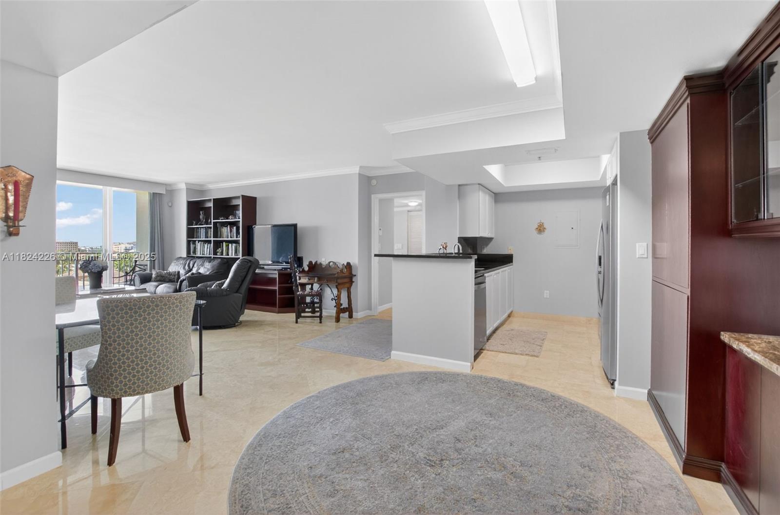 99 Southeast Mizner Boulevard, Unit 821 Boca Raton, FL 33432 - Photo 2 of 23 a view of kitchen with furniture and refrigerator