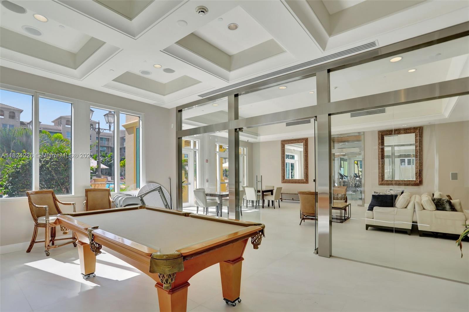 99 Southeast Mizner Boulevard, Unit 821 Boca Raton, FL 33432 - Photo 21 of 23 a view of a livingroom with furniture and large windows