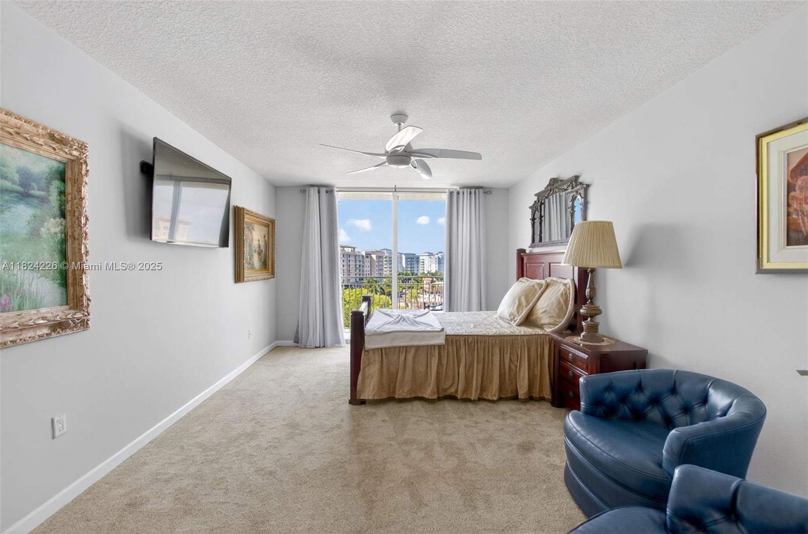 99 Southeast Mizner Boulevard, Unit 821 Boca Raton, FL 33432 - Photo 6 of 23 a bed room with furniture and a window