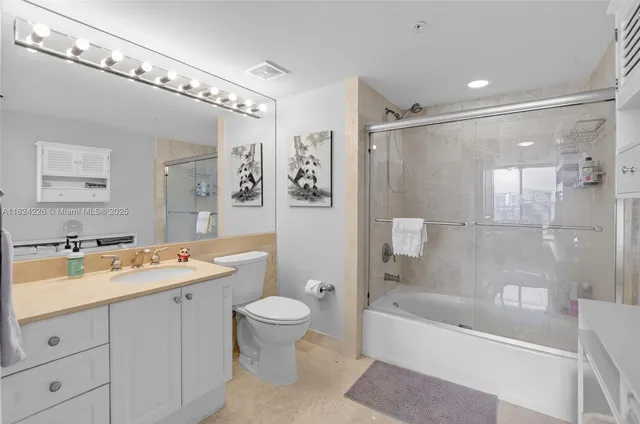 a spacious bathroom with a bathtub shower sink mirror and toilet