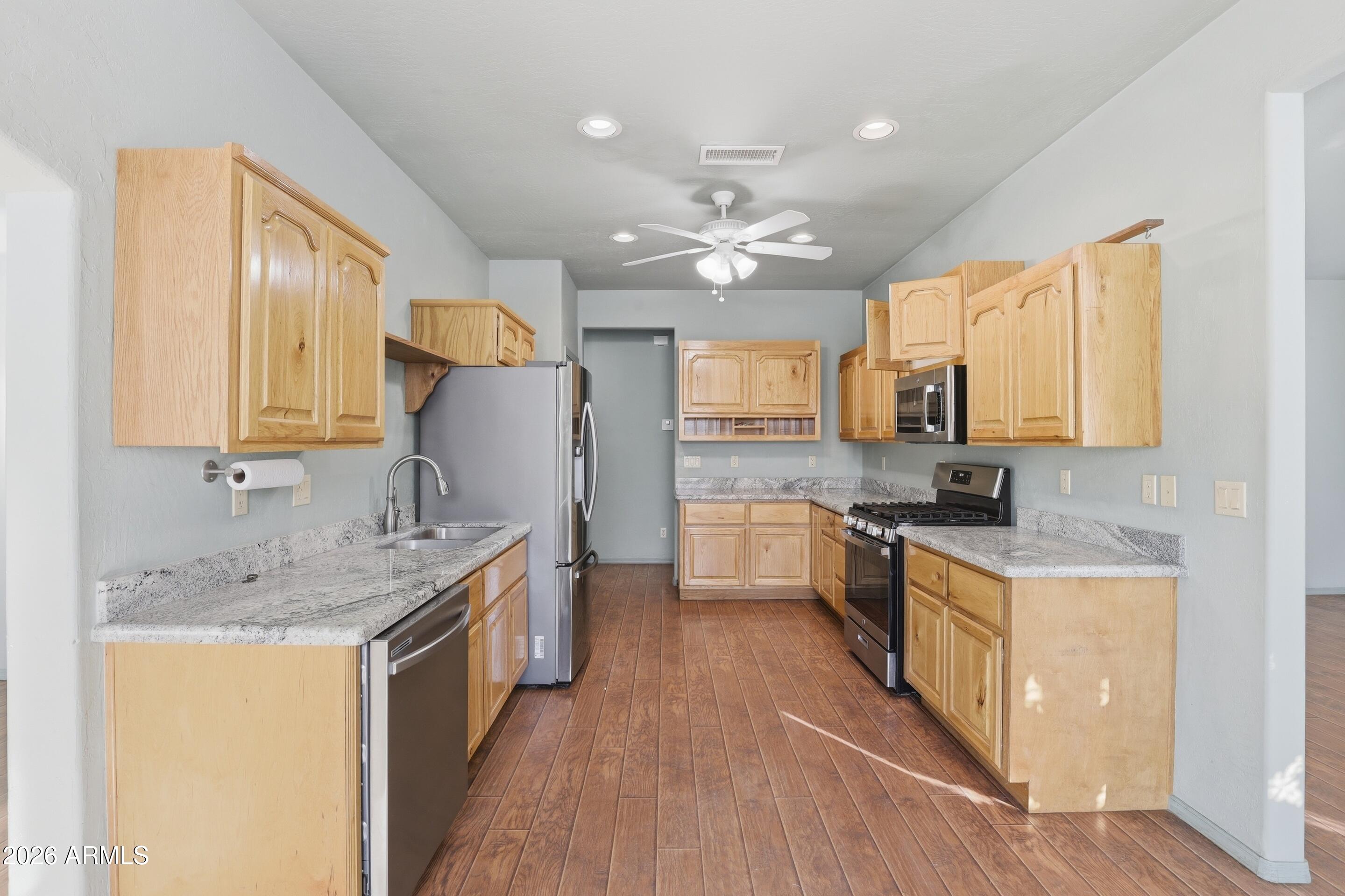 228 Windmill Road Payson, AZ 85541 - Photo 17 of 42 a kitchen with a sink stove top oven and refrigerator