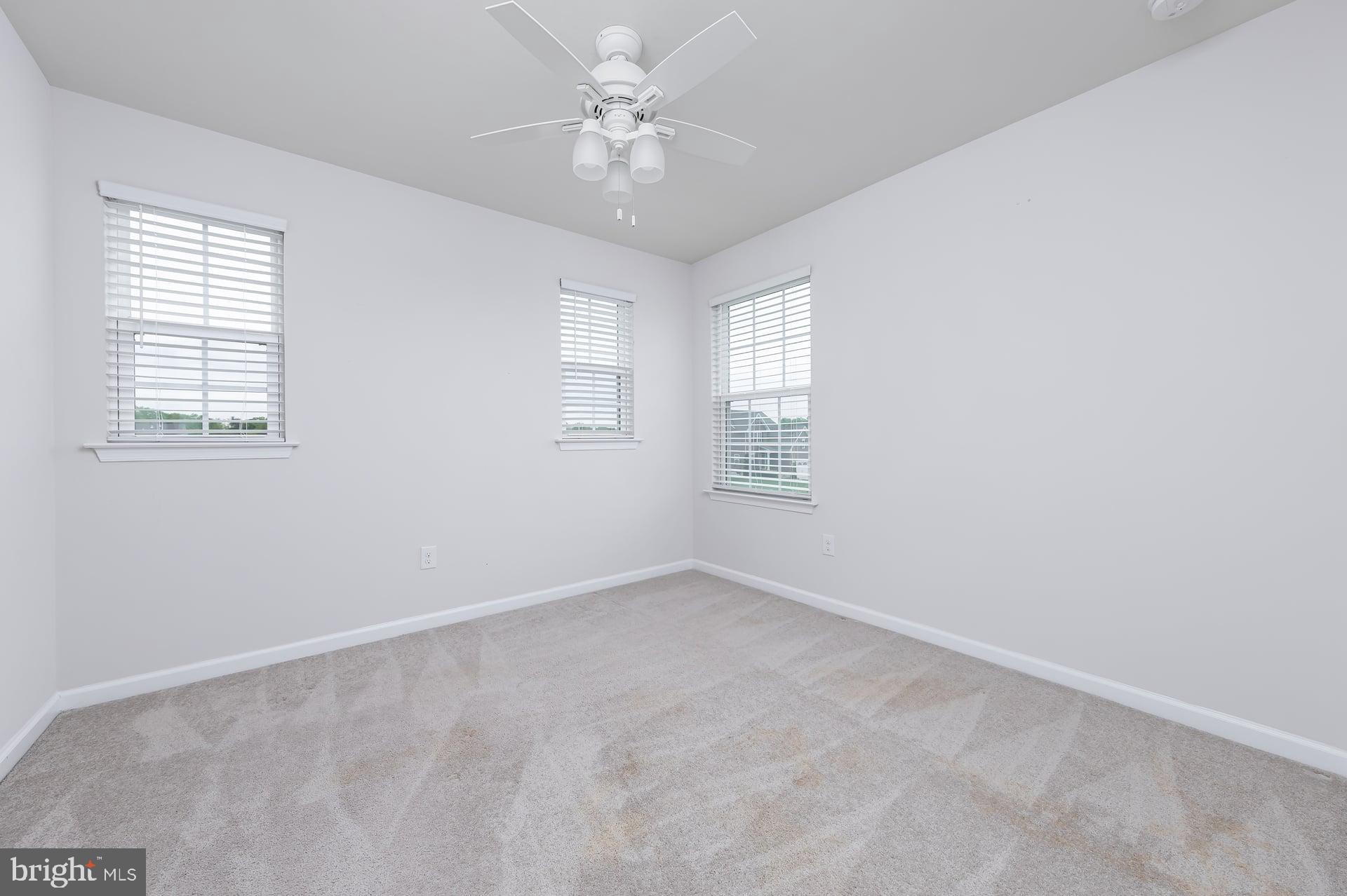 53 Oak Ln. Carneys Point, NJ 08069 - Photo 15 of 28 an empty room with windows and fan