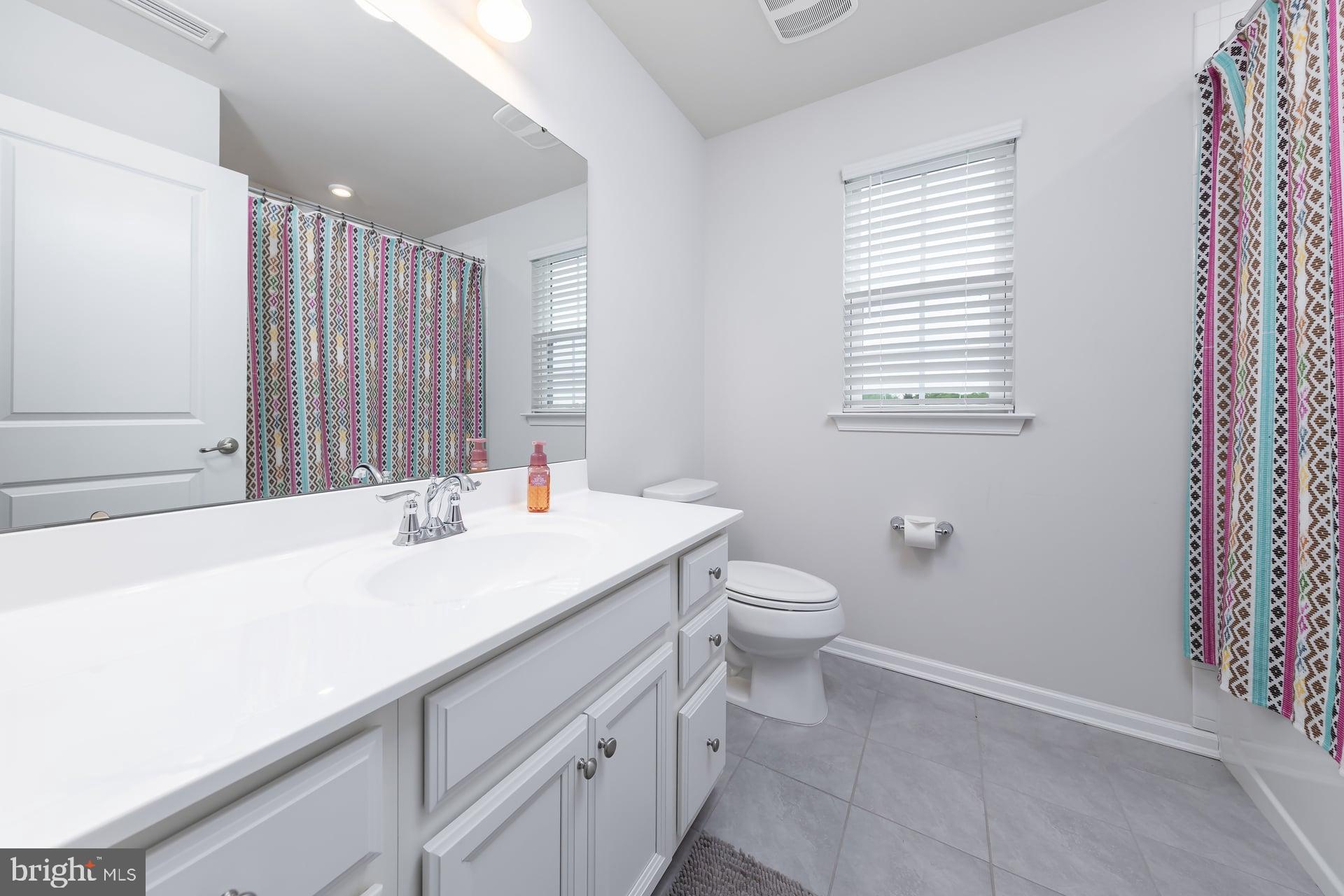 53 Oak Ln. Carneys Point, NJ 08069 - Photo 16 of 28 a bathroom with a sink a toilet and a window