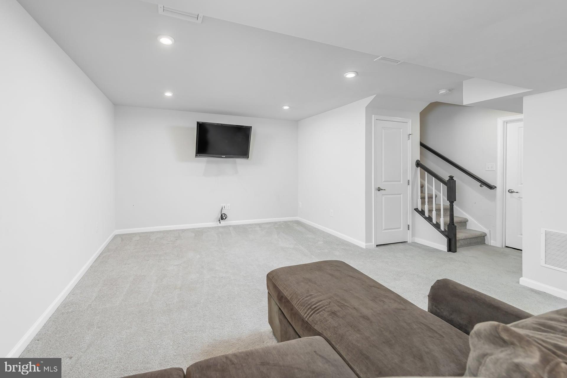 53 Oak Ln. Carneys Point, NJ 08069 - Photo 21 of 28 a living room with couches and a flat screen tv