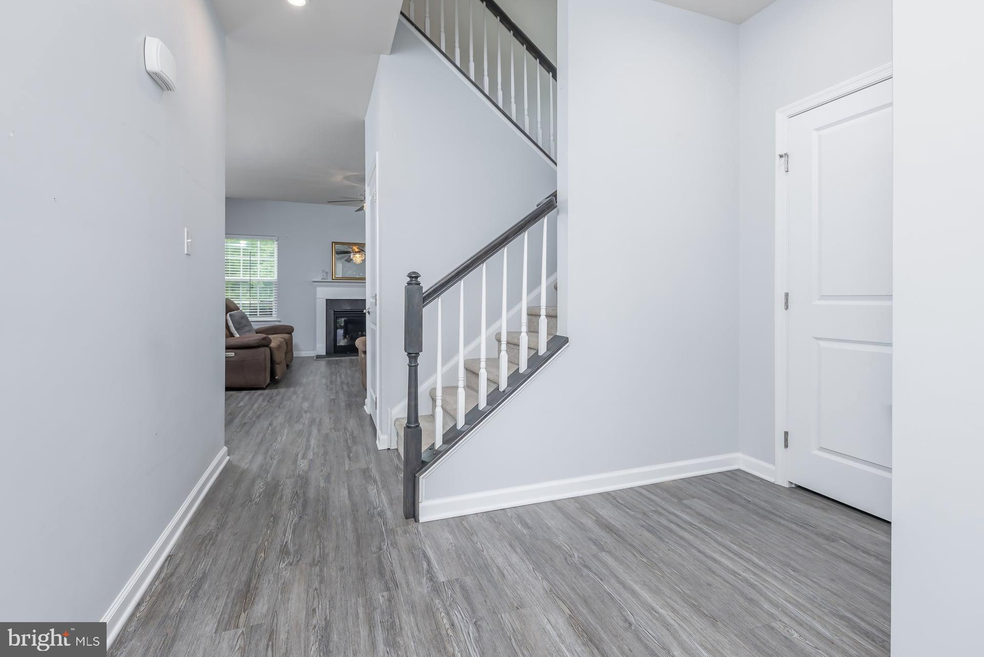 53 Oak Ln. Carneys Point, NJ 08069 - Photo 3 of 28 a view of a hallway with wooden floor and entryway