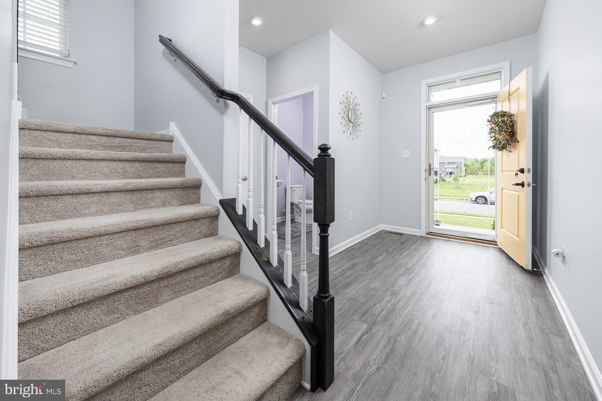 53 Oak Ln. Carneys Point, NJ 08069 - Photo 4 of 28 a view of an entryway with wooden floor and stairs