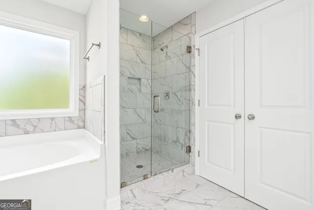 a bathroom with a shower and a bathtub