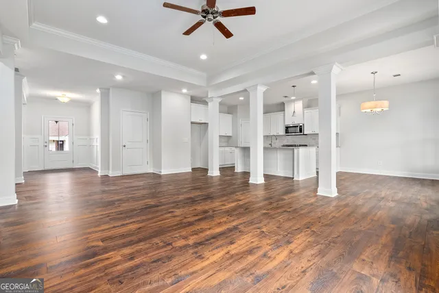 a view of a kitchen with a sink and a refrigerator