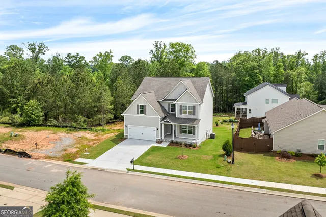 an aerial view of a house with a yard table and chairs
