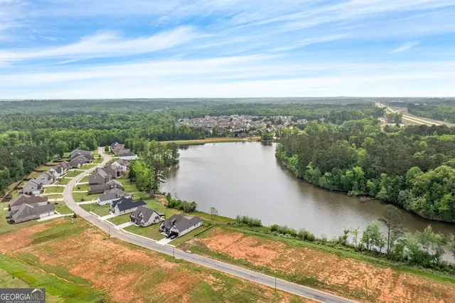 an aerial view of a house with a lake view