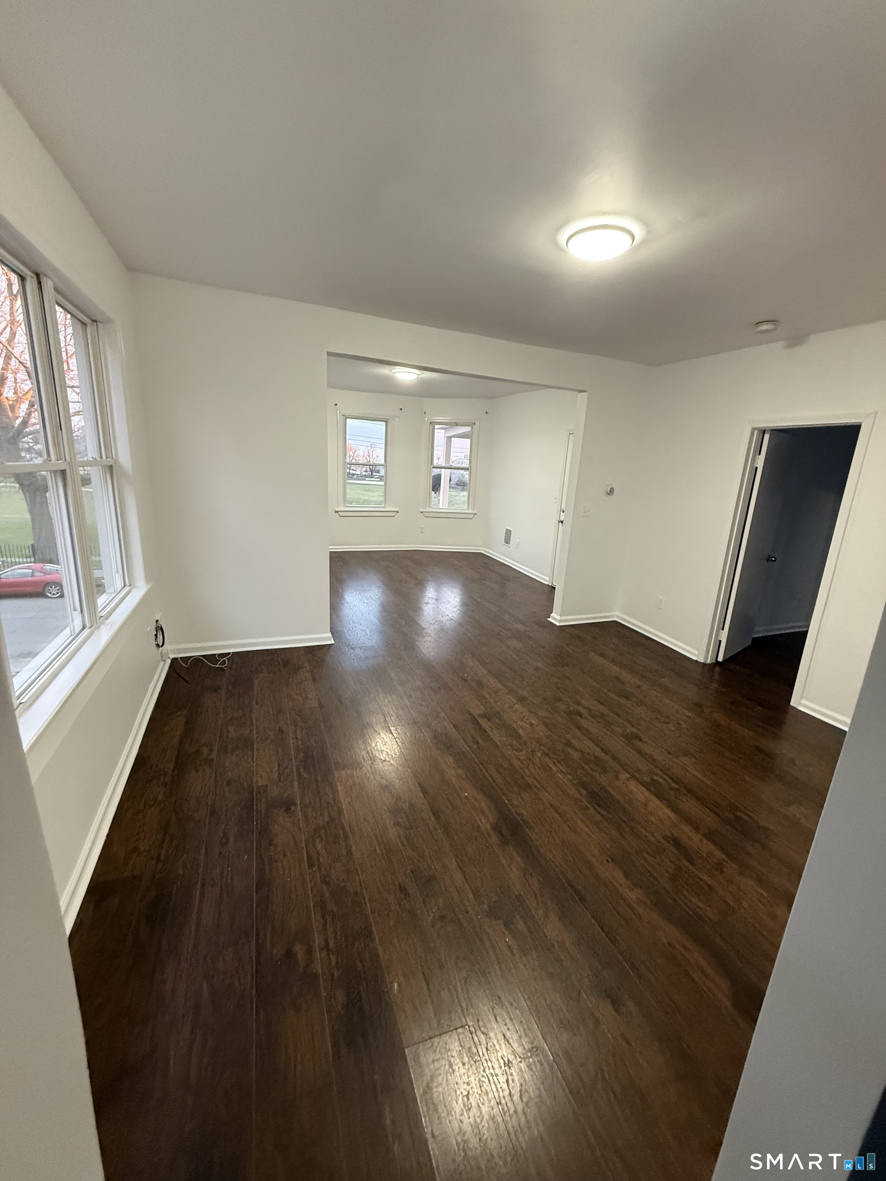 127 Eagle Street Bridgeport, CT 06607 - Photo 6 of 14 There is a living room that opens into a dining room.