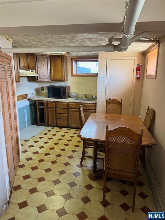 581 Broad Street, Unit 2 Carlstadt, NJ 07072 - Photo 13 of 15 a kitchen with a sink a stove a microwave and cabinets