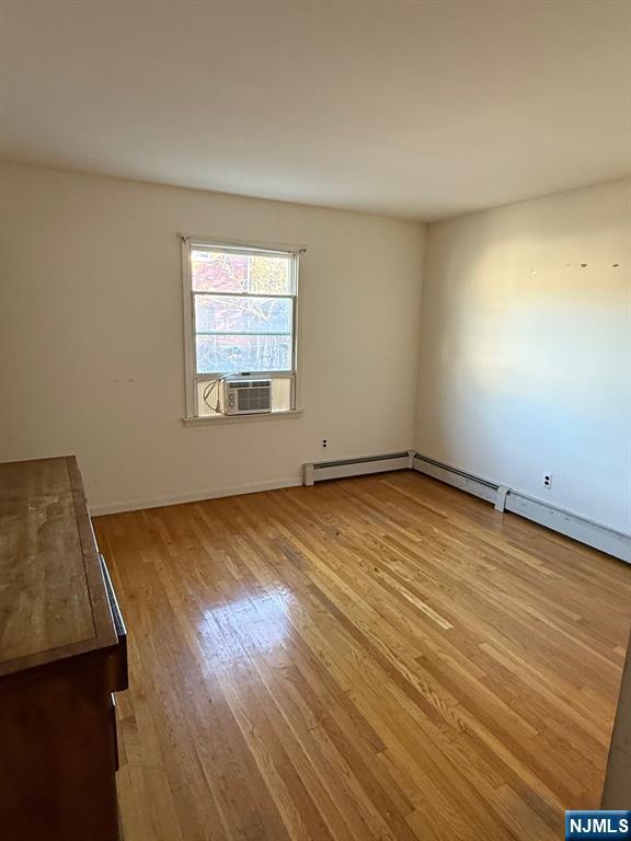 581 Broad Street, Unit 2 Carlstadt, NJ 07072 - Photo 8 of 15 a view of an empty room with wooden floor and a window