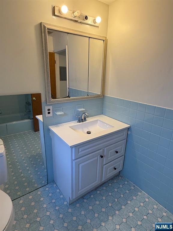 581 Broad Street, Unit 2 Carlstadt, NJ 07072 - Photo 10 of 15 a bathroom with a sink vanity and mirror