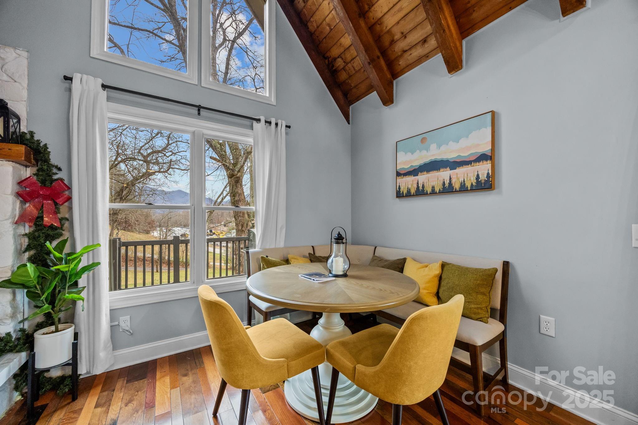 540 Toot Hollow Road Bryson City, NC 28713 - Photo 13 of 47 a view of a dining room with furniture window and wooden floor