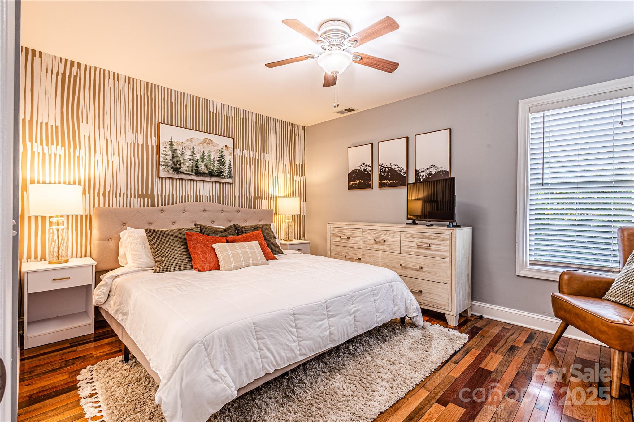 540 Toot Hollow Road Bryson City, NC 28713 - Photo 25 of 47 a bedroom with a bed and a chandelier