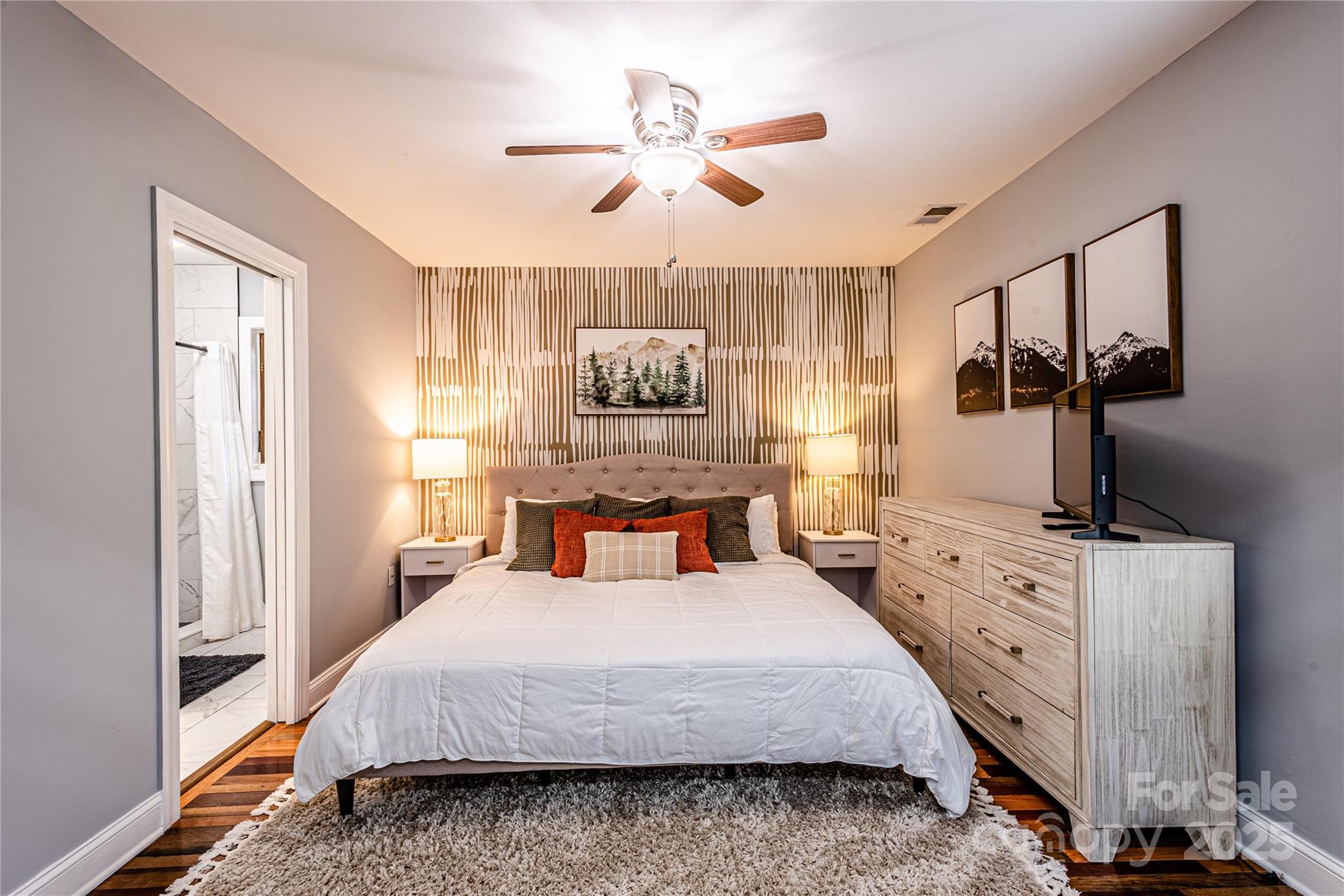 540 Toot Hollow Road Bryson City, NC 28713 - Photo 26 of 47 a bedroom with a large bed and a flat tv screen on dresser