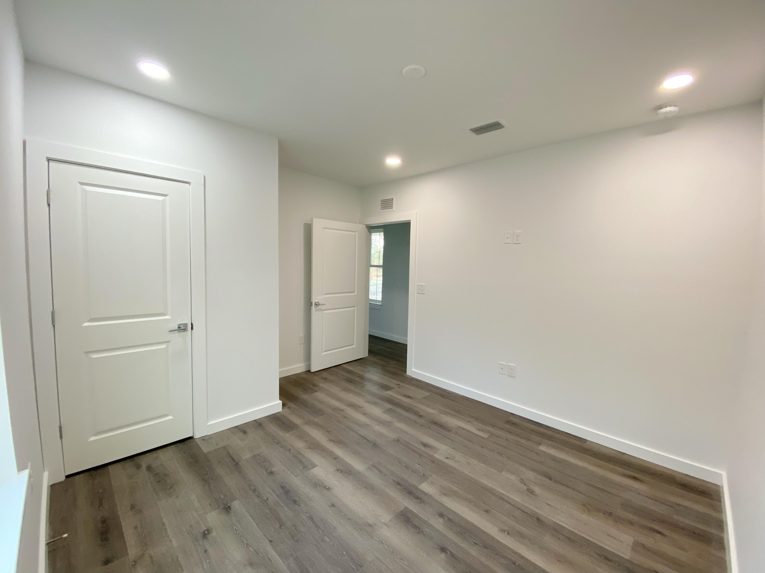 211 West Renoir Road DeFuniak Springs, FL 32433 - Photo 12 of 19 a view of an empty room with wooden floor