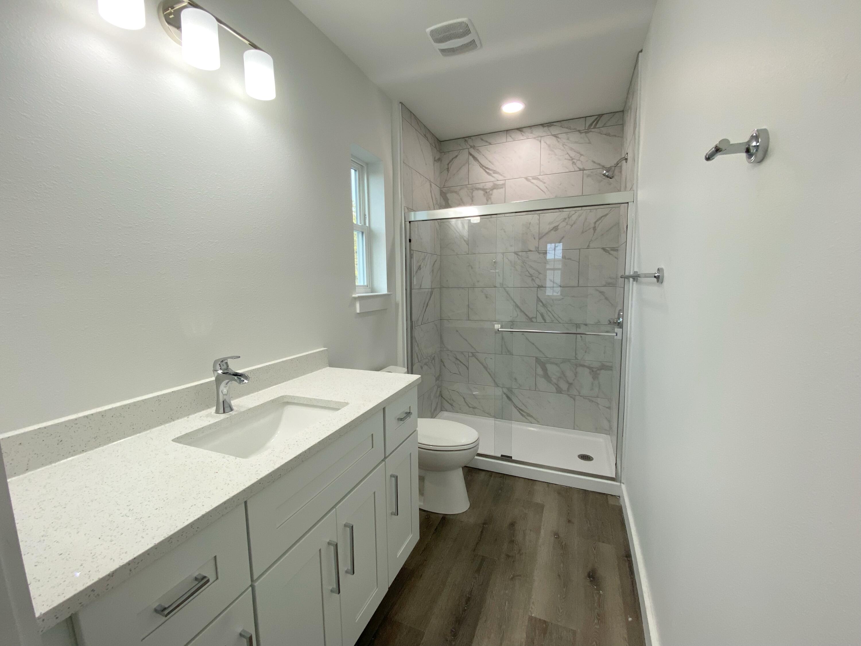 211 West Renoir Road DeFuniak Springs, FL 32433 - Photo 15 of 19 a bathroom with a sink a toilet and shower