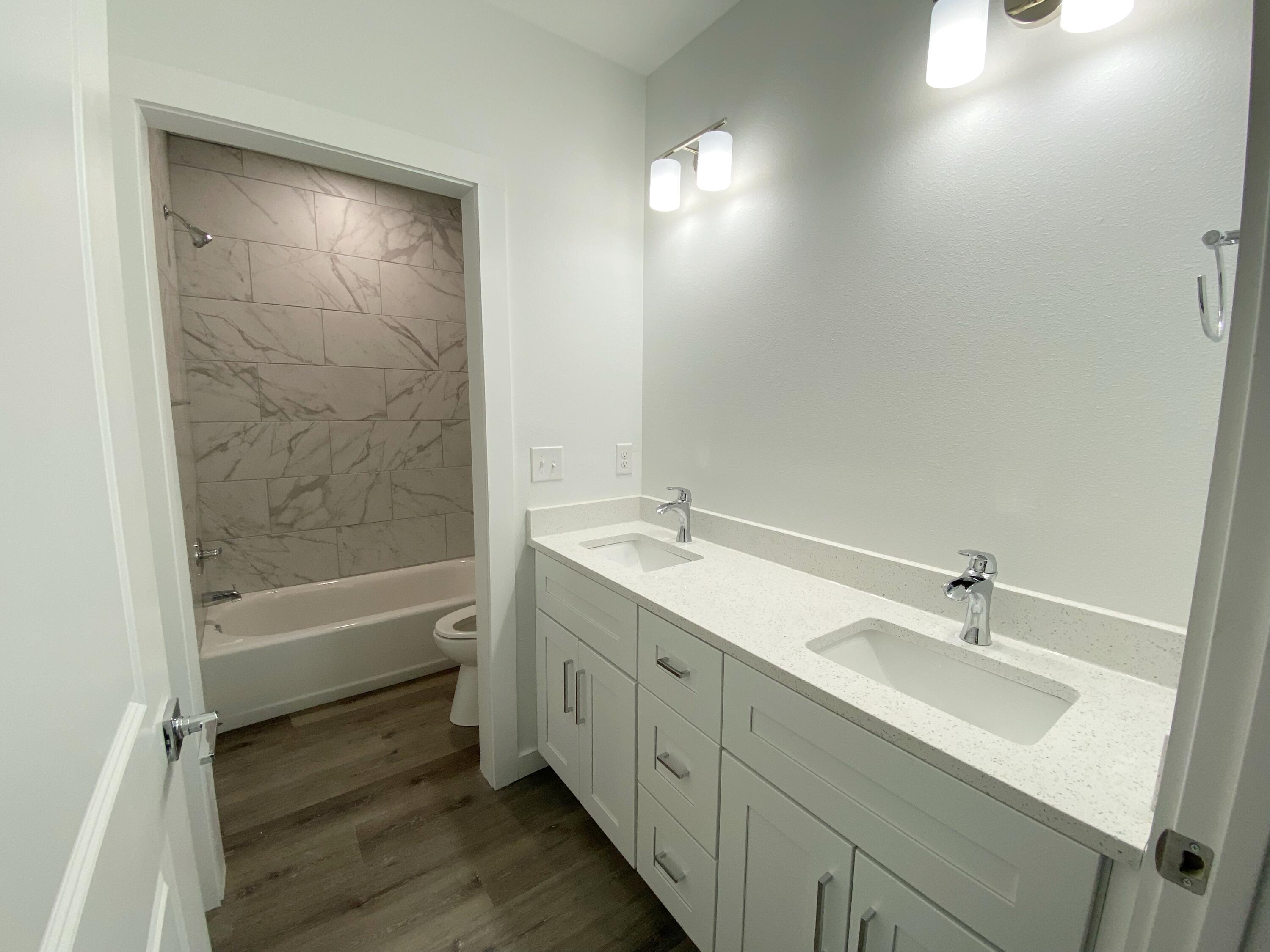 211 West Renoir Road DeFuniak Springs, FL 32433 - Photo 16 of 19 a bathroom with a tub sink vanity granite and a mirror