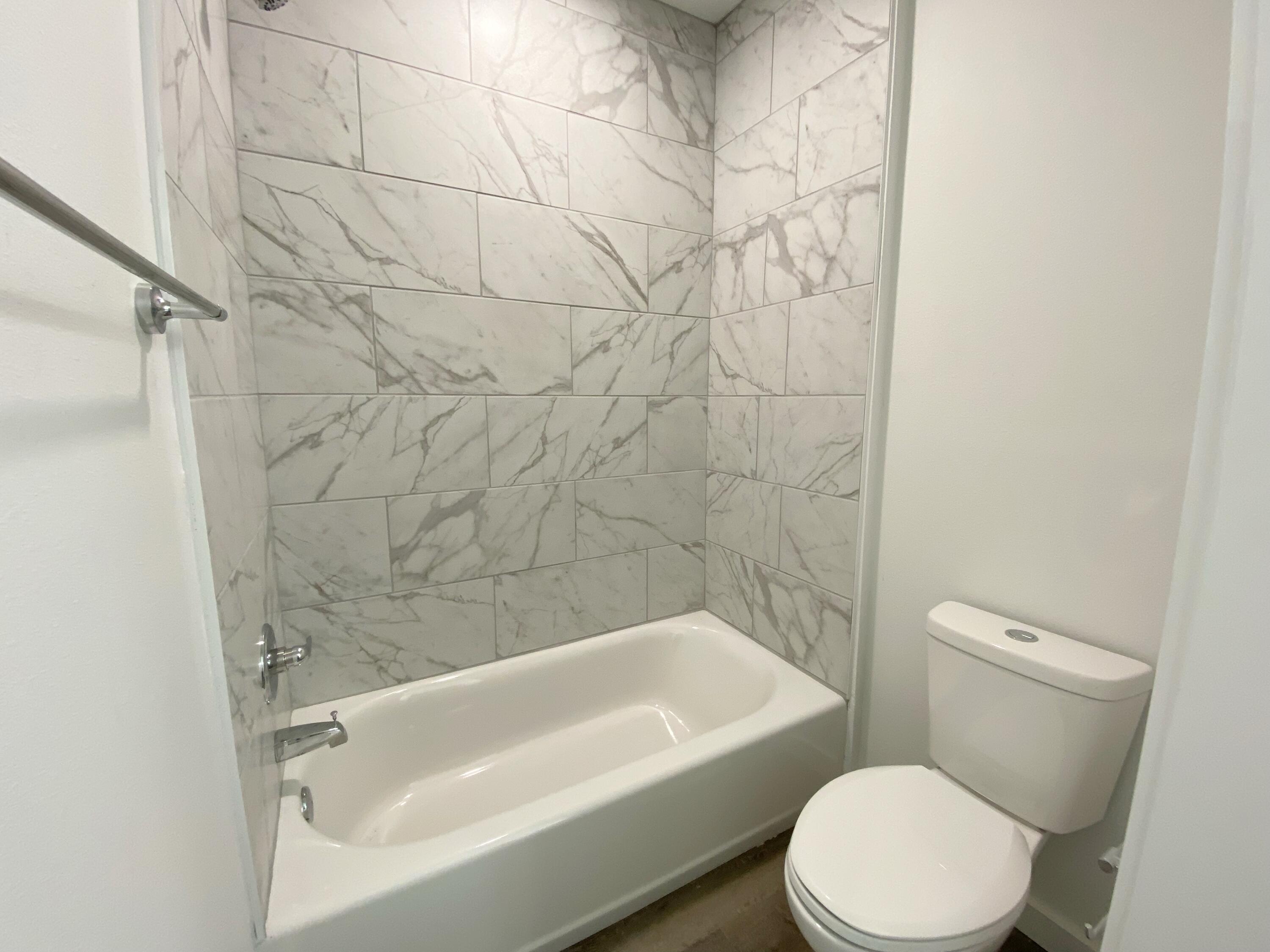 211 West Renoir Road DeFuniak Springs, FL 32433 - Photo 17 of 19 a white bath tub sitting next to a white toilet